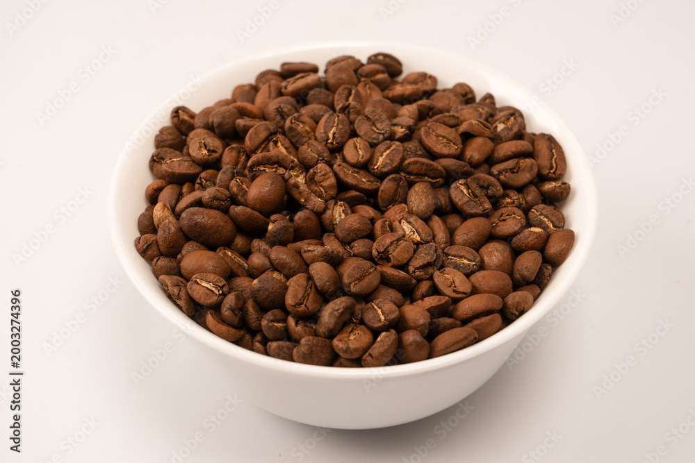 Fototapeta premium Coffee beans on a white background. Top view. Coffee beans texture.