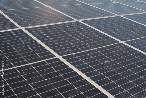 Tableau sur toile close up Rows of solar panels stretch across the ground