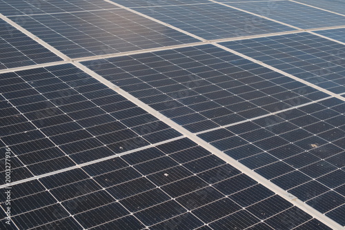 Photos close up Rows of solar panels stretch across the ground