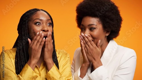 Two women reacting with surprise and gossip.