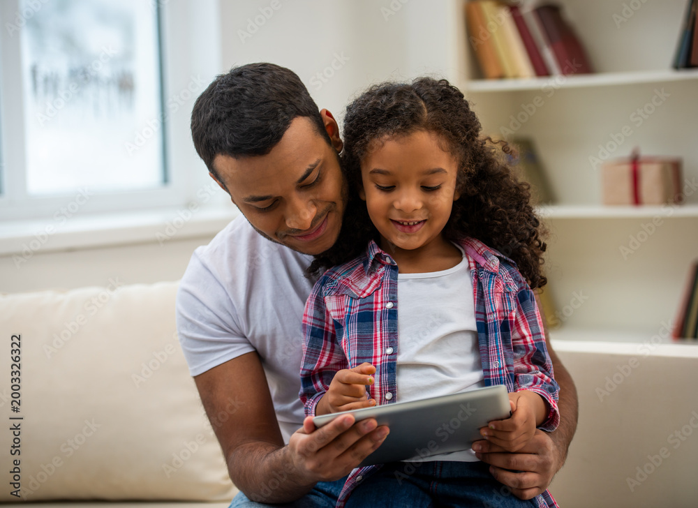 Fototapeta premium Father and daughter using tablet together.