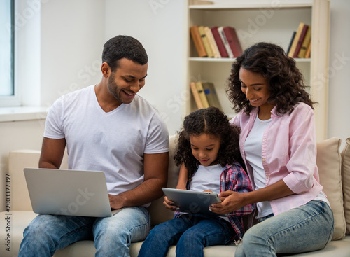 Family using devices together at home.