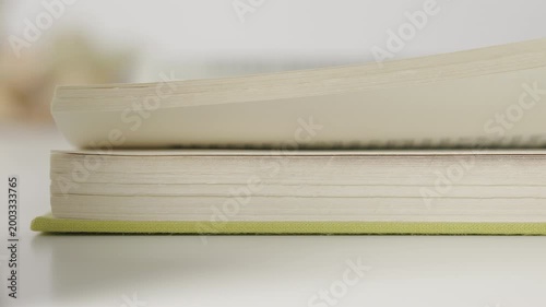 Slowly flipping book pages detail