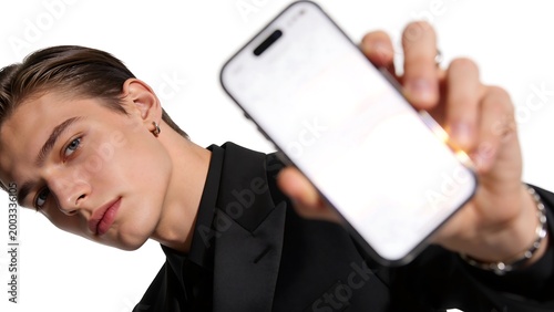 Young man showing blank smartphone screen.