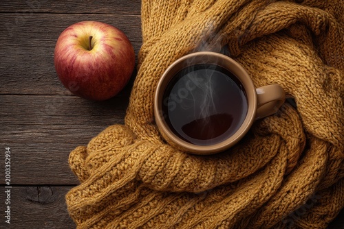 Cozy Autumn Still Life with a Steaming Mug, Red Apple, and Yellow Knitted Scarf on a Wooden Table.
