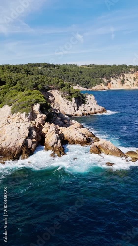 Mediterranean sea rocky coastline covered forest and calm sea waves. Scenic aerial perspective of seashore South France