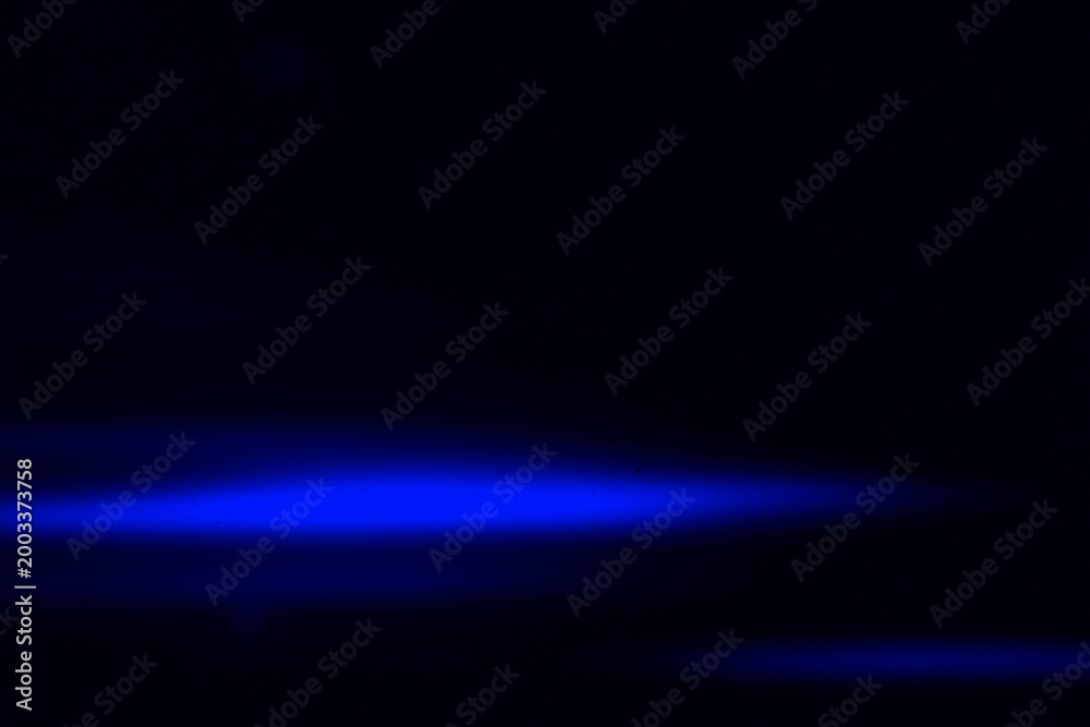 Fototapeta premium Deep blue glowing light streak on black background. Clean and minimal abstract design ideal for tech, sci-fi, and digital visual concepts