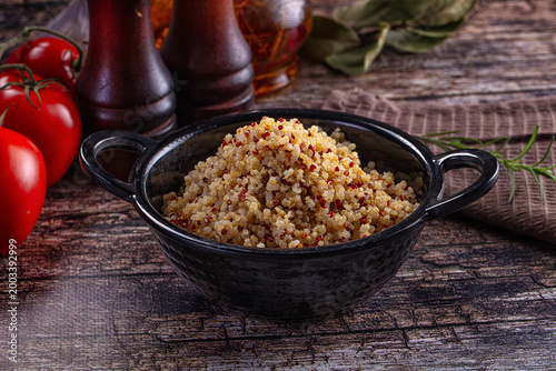 Fotografie Healthy cooked tri-color quinoa in a bowl with fresh tomatoes and rosemary on a