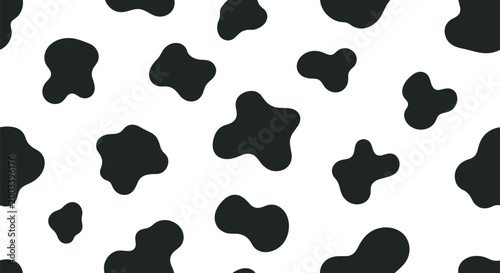 Seamless cow print pattern with black irregular spots on a white background creating a classic animal skin texture for fabric design.
