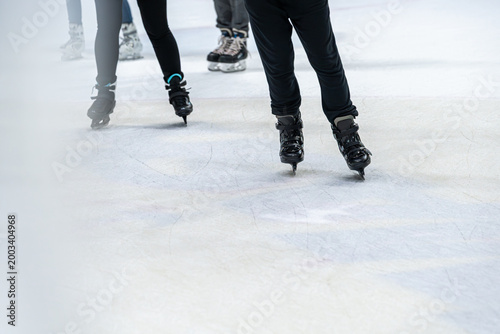 People ice skating on a blurry ice rink