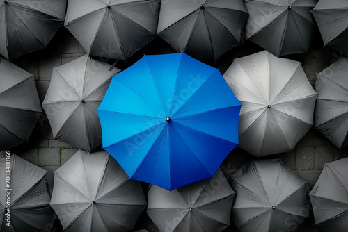 Blue Umbrella Standing Out Among Gray Umbrellas – Symbol of Innovation and Leadership