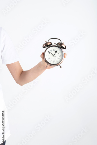Hand holding a vintage alarm clock symbolizing punctuality and deadlines