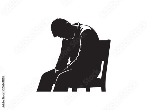 Man sitting on a chair with his head down in silhouette.