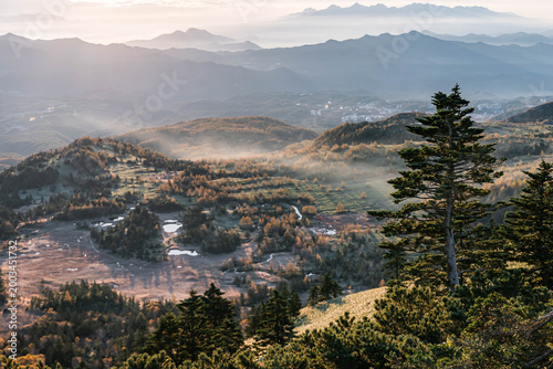 Sunrise over misty mountain valley with sea of clouds, autumn landscape in Japan