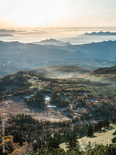 Sunrise over misty mountain valley with sea of clouds, autumn landscape in Japan