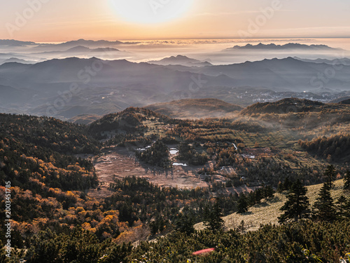 Sunrise over misty mountain valley with sea of clouds, autumn landscape in Japan