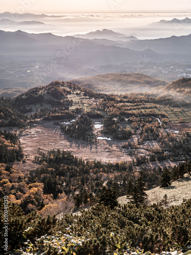 Sunrise over misty mountain valley with sea of clouds, autumn landscape in Japan