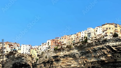Close up of colorful residential buildings built on the edge of a white cliff