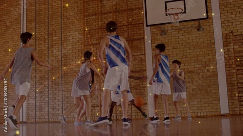 School players dribbling ball toward hoop on court, scrambling for possession, gold dust appearing