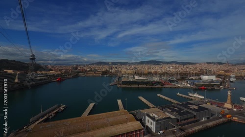 Wide panoramic view of city harbor and industrial port with mountains in background