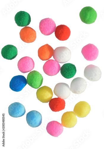 Colorful pom poms scattered white background. High angle view vibrant fuzzy craft balls textile supply creative hobbies children school art projects playful decorative texture isolated cutout