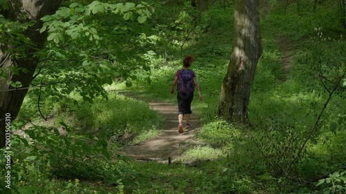 Woman hiking forest trail