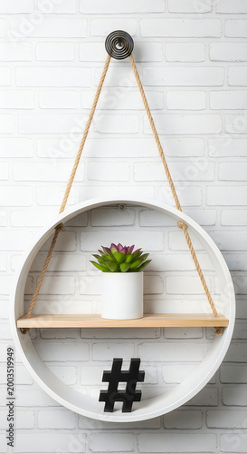Modern round wall shelf with a potted succulent and black hashtag sign.