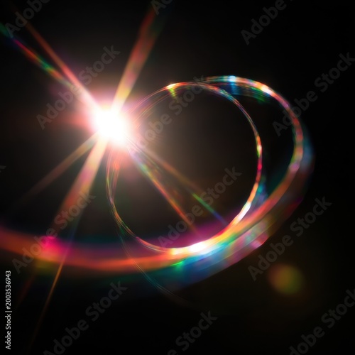 Vibrant lens flare effect with rainbow rings and starburst light on dark background