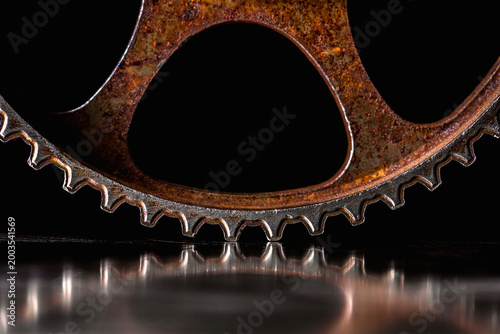 Rusty Steel Timing Gear with Reflection on Metal Surface