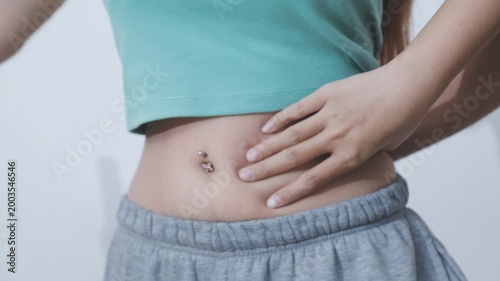 Overweight woman body with hands touching belly fat