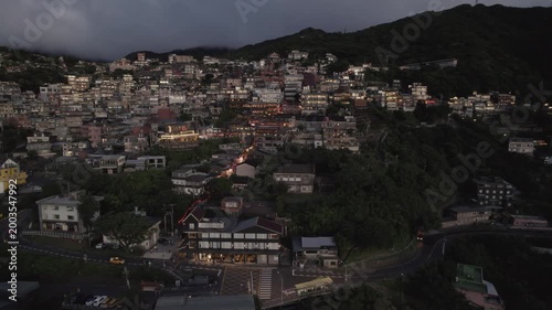 Taiwan, Jiufen town in the evening, Aerial drone of old town Jiufen, famous landmark tourist village on the mountain in Taiwan full of houses on a steep hill and a famous street full of lanterns.