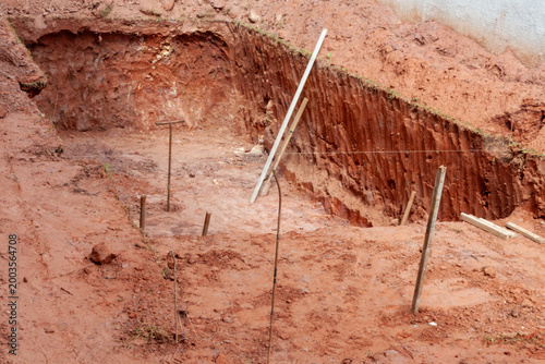 Fotografie Excavated hole for a swimming pool at a residential construction site