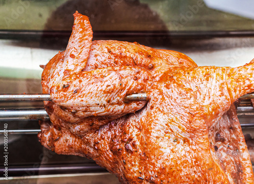Grilled chicken is cooked on a grill oven, this image is suitable for culinary topics and food related articles, as well as for catering concepts
