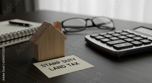 Stamp duty land tax concept with calculator and house model
