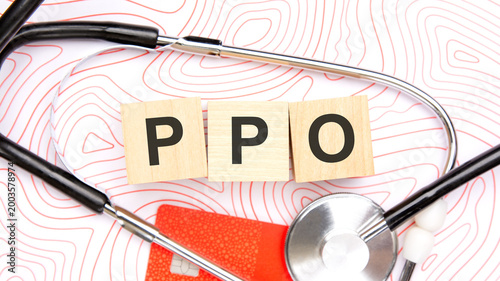 PPO text on wooden blocks with stethoscope and credit card.