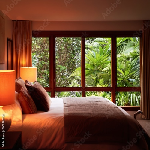 Cozy Room With Large Windows and Warm Lighting in a Tropical Setting
