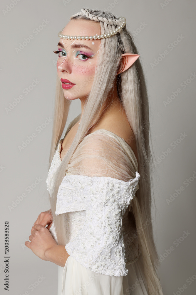 Fototapeta premium Portrait of beautiful elf girl on grey background