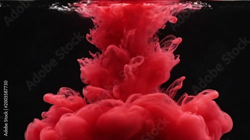 Red ink drops into water creating dynamic patterns on a black background at 30 frames per second