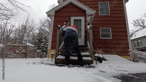 Time-lapse woman shoveling and salting stairs after the snow storm in February