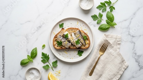 Open sardine toast on white plate with basil parsley lemon and sea salt for clean flatlay food background and recipe banner design