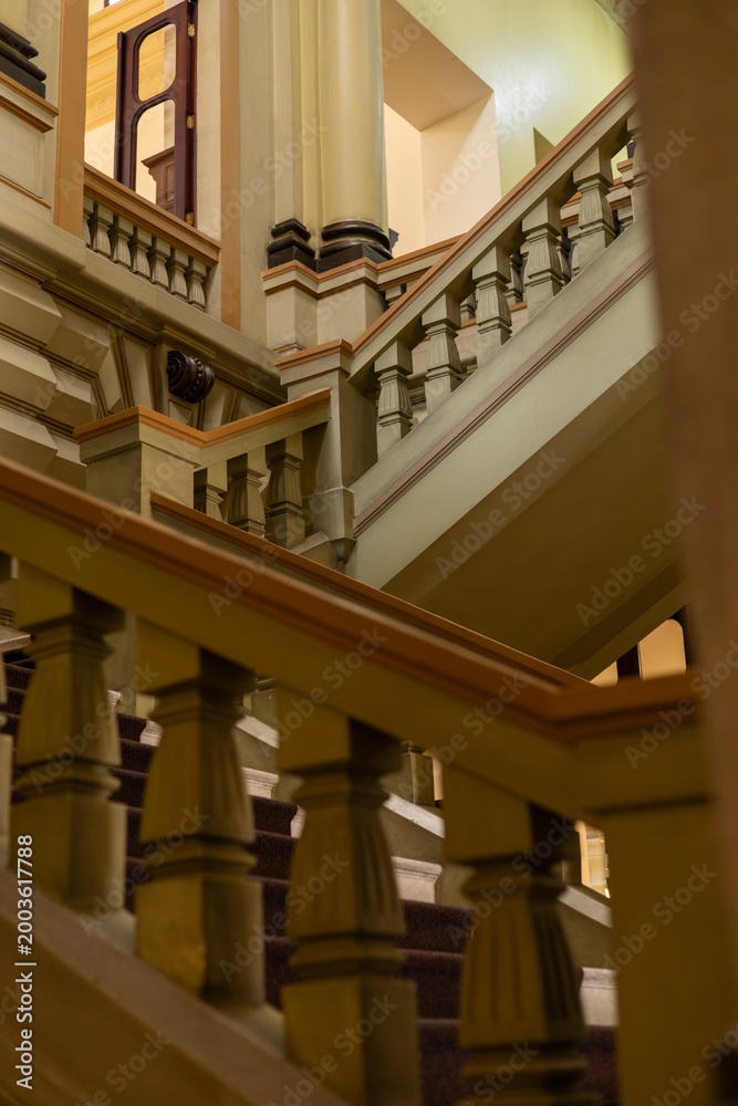 Fototapeta premium Beautiful colonial staircase featuring elegant historic architecture and classic design details in natural light.