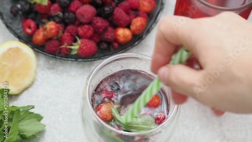 Summer drinks, colored cocktails on table. Lemonade, mojito, strawberry lemonade, tonic water. A refreshing summer drink with raspberries and blueberries, a detox drink for weight loss and keeping fit