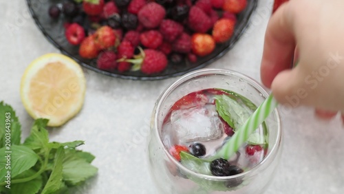Summer drinks, colored cocktails on table. Lemonade, mojito, strawberry lemonade, tonic water. A refreshing summer drink with raspberries and blueberries, a detox drink for weight loss and keeping fit