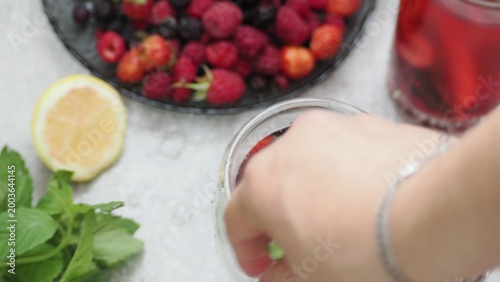 Summer drinks, colored cocktails on table. Lemonade, mojito, strawberry lemonade, tonic water. A refreshing summer drink with raspberries and blueberries, a detox drink for weight loss and keeping fit