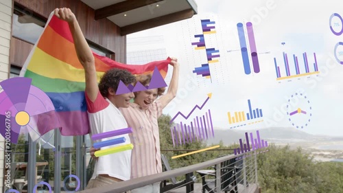 Two men on balcony raising rainbow flag, honoring pride while marketing charts flowing, obscuring