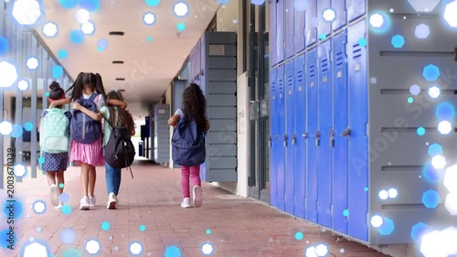 School girls leaving class and walking corridor, lockers backpacks with bokeh overlay intensifying