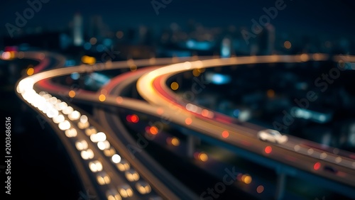 interchange. City lights blur into golden trails at night, portraying urban energy in motion. mobility guides, transit brochures, designed for mobility and urban transit guides, used by professors.