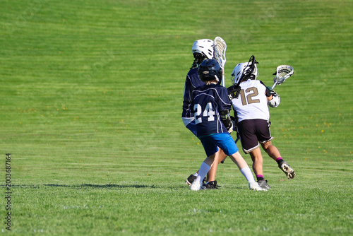Young boys playing Lacrosse game
