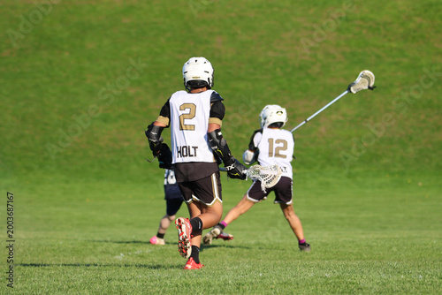 Young boys playing Lacrosse game