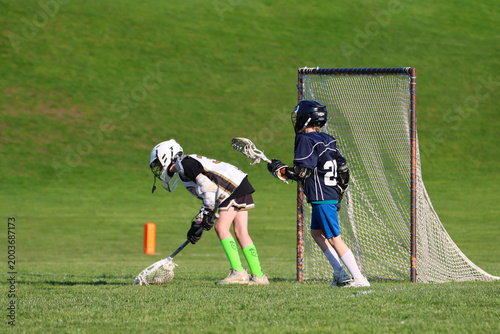 Young boys playing Lacrosse game